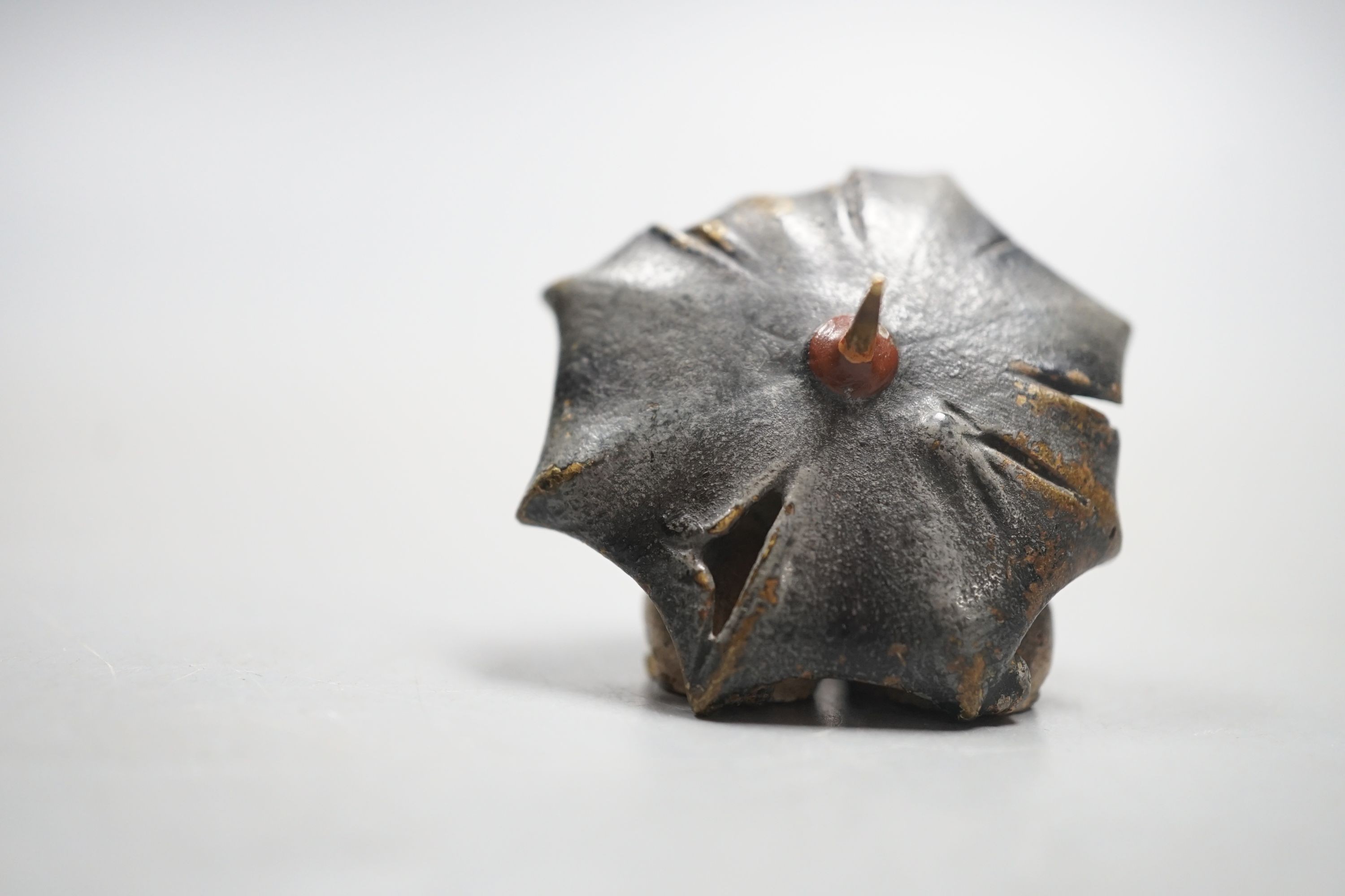 A small Austrian cold painted bronze group of two pug dogs under a rugged umbrella, 3cm
